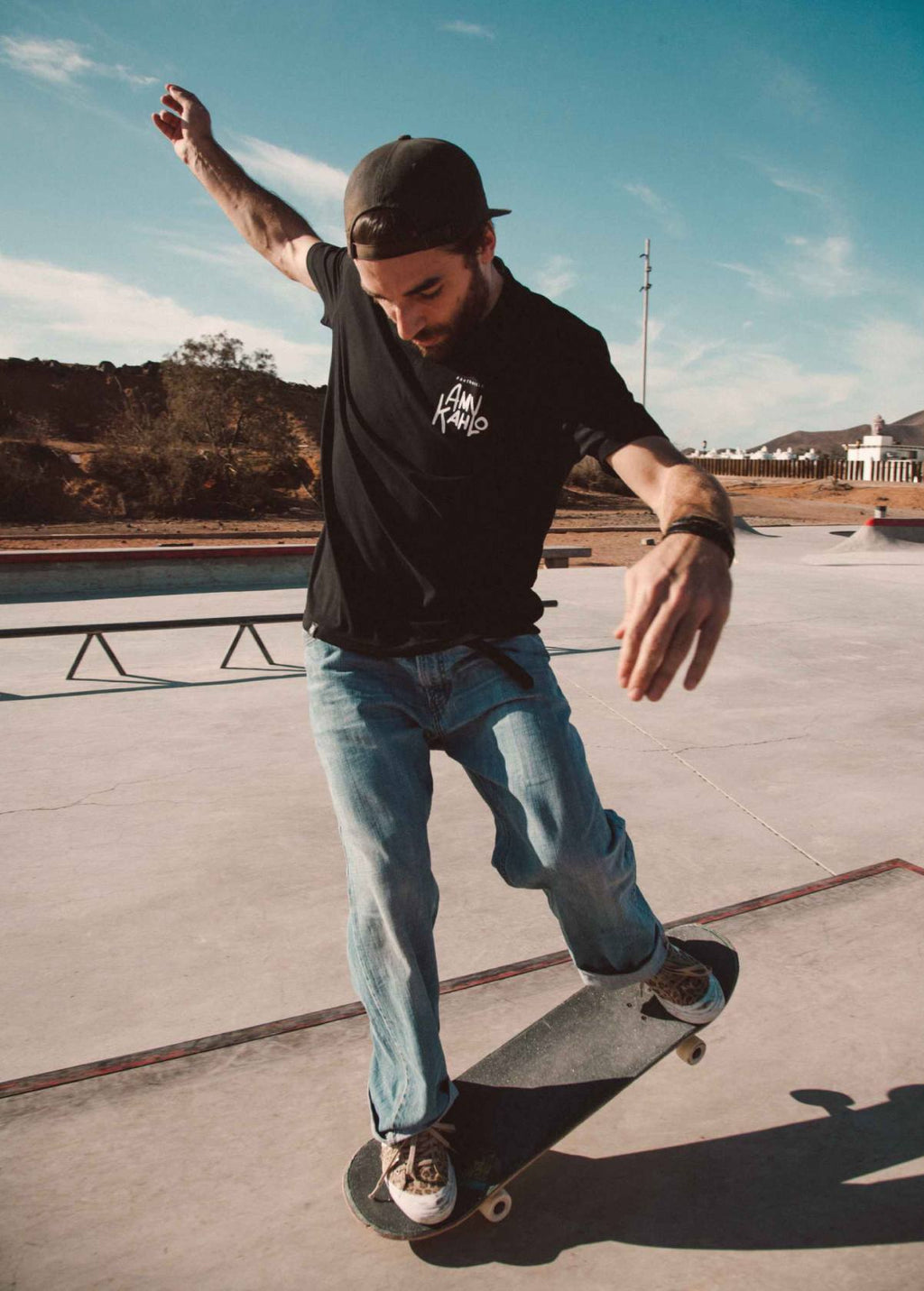 Hombre con camiseta unisex “Amy Kahlo” negra, vista de frente. Arte digital independiente creado por Carolina Gallo – LA GALLO ART.