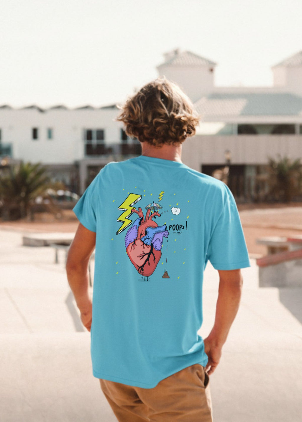 Hombre con camiseta unisex “Corazón” color Aqua Blue, vista de espalda. Arte digital independiente impreso en prenda ecológica.