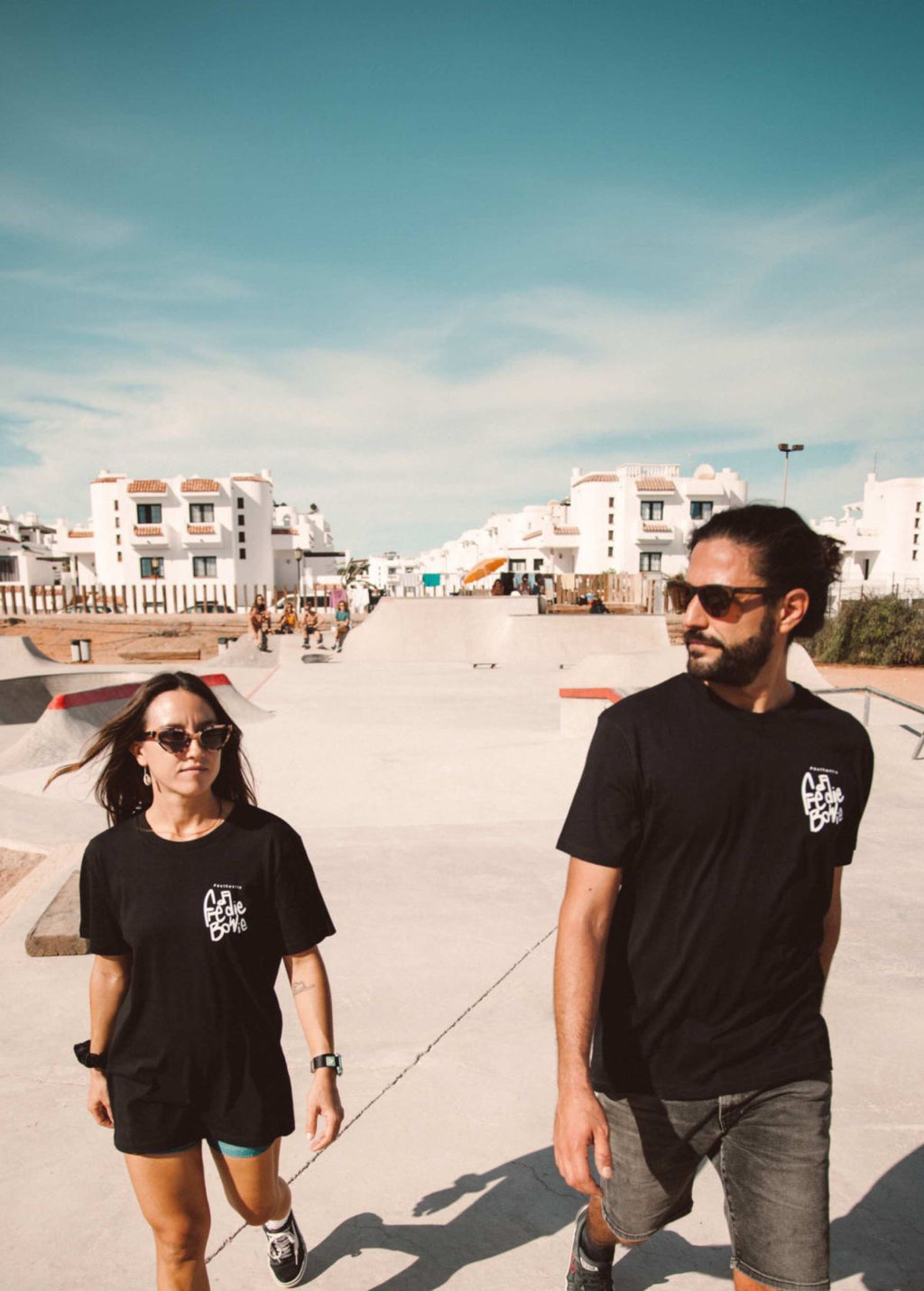 Pareja de modelos unisex con camiseta “Freddie Bowie” negra, vista de frente. Diseño independiente de LA GALLO ART.